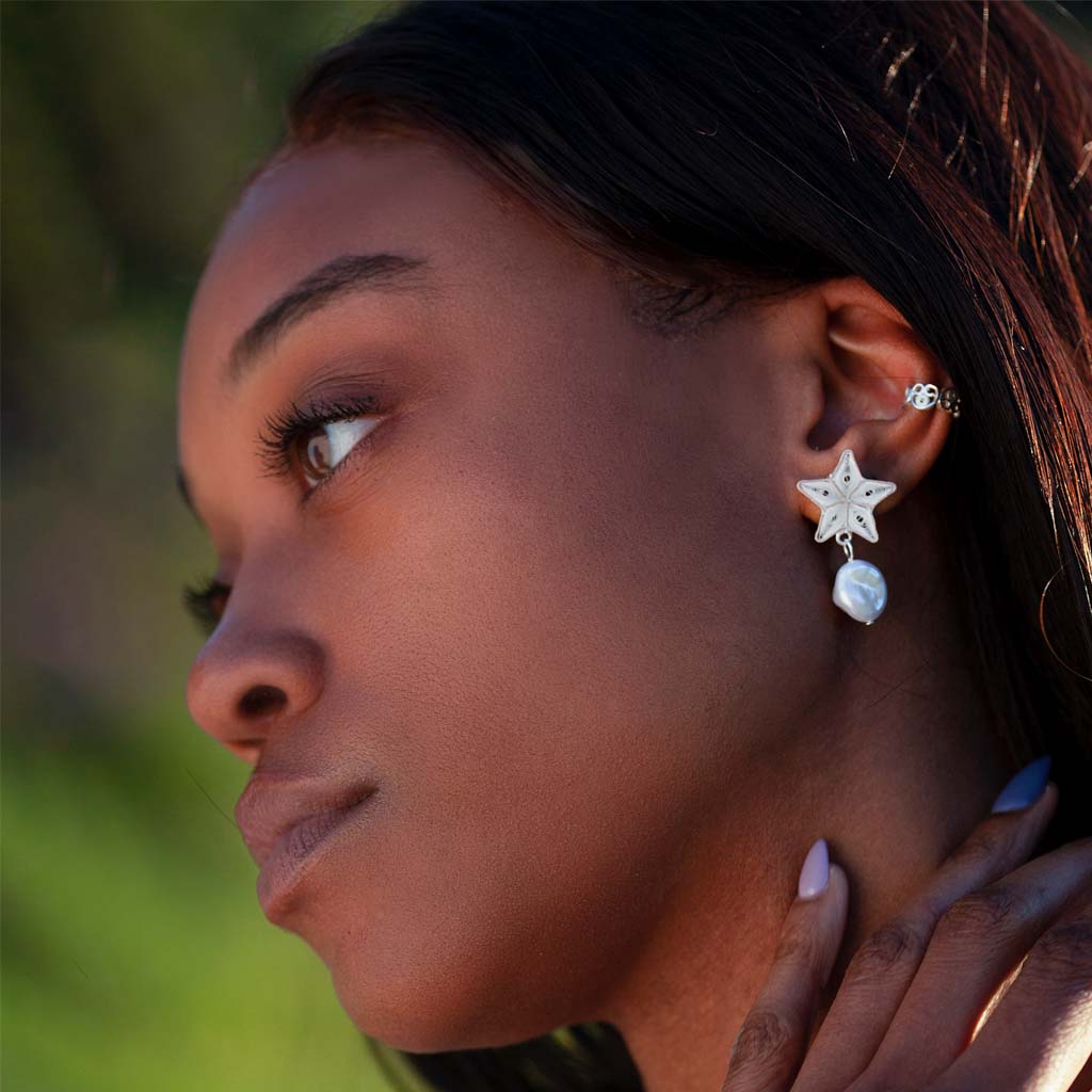 Model wearing the OH Voila Sea Star & Pearl studs Silver & Iris Ear cuf;f