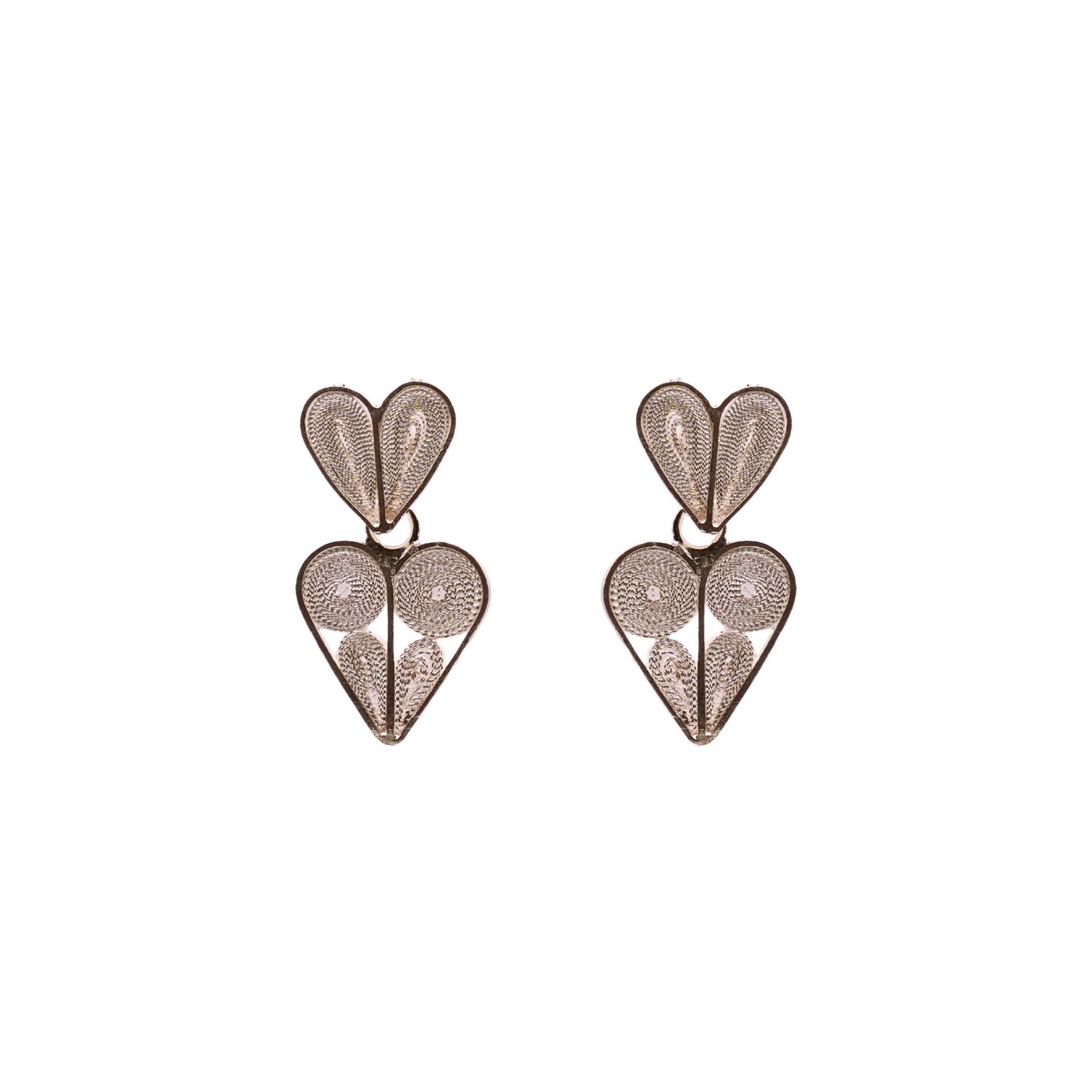 Heart-shaped earrings with intricate designs on a white background