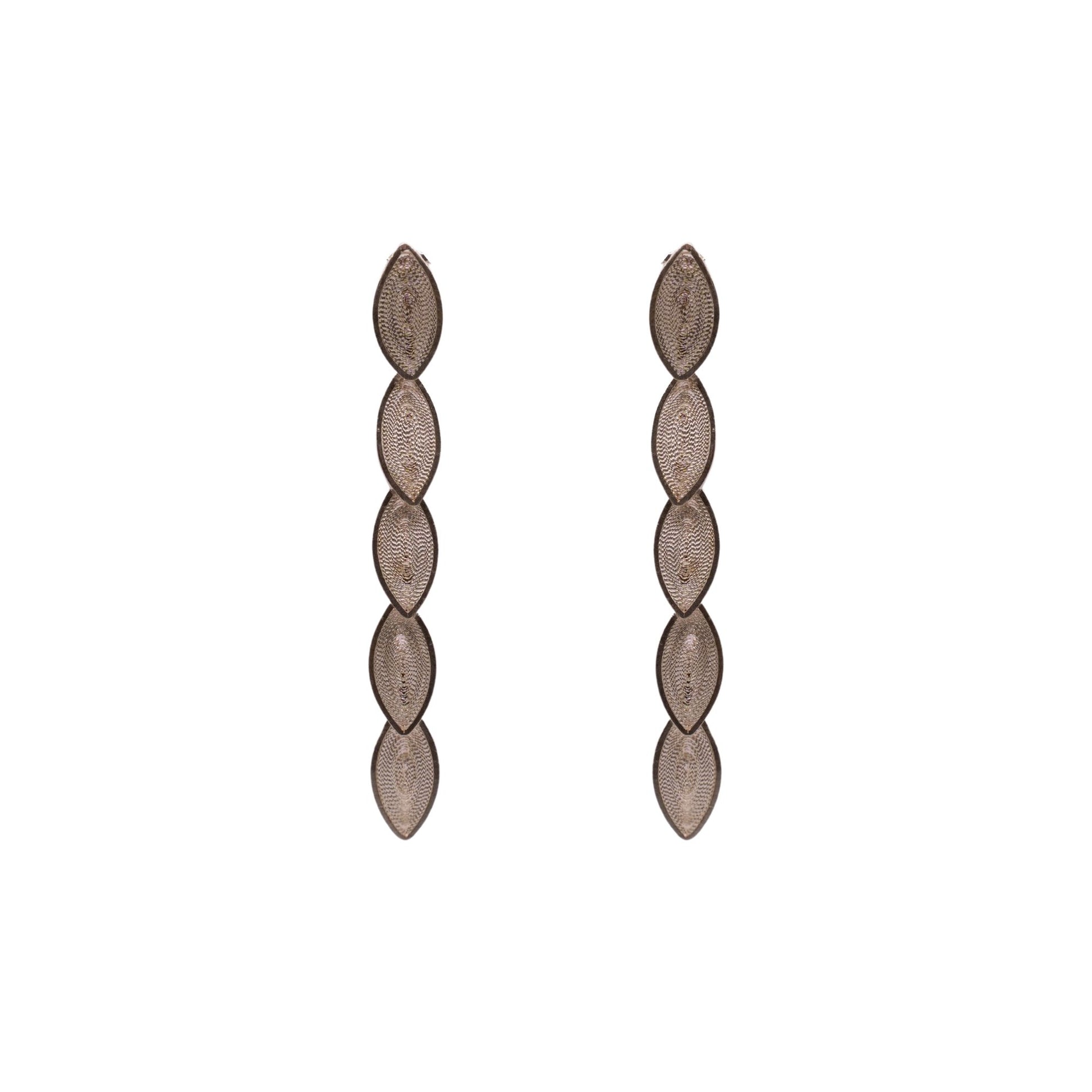 Pair of long, thin earrings with a textured design on a white background