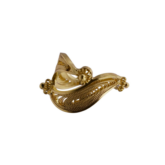 Gold earcuff with intricate design on a white background